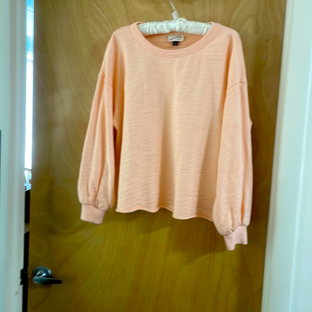 Peach colored sweater.